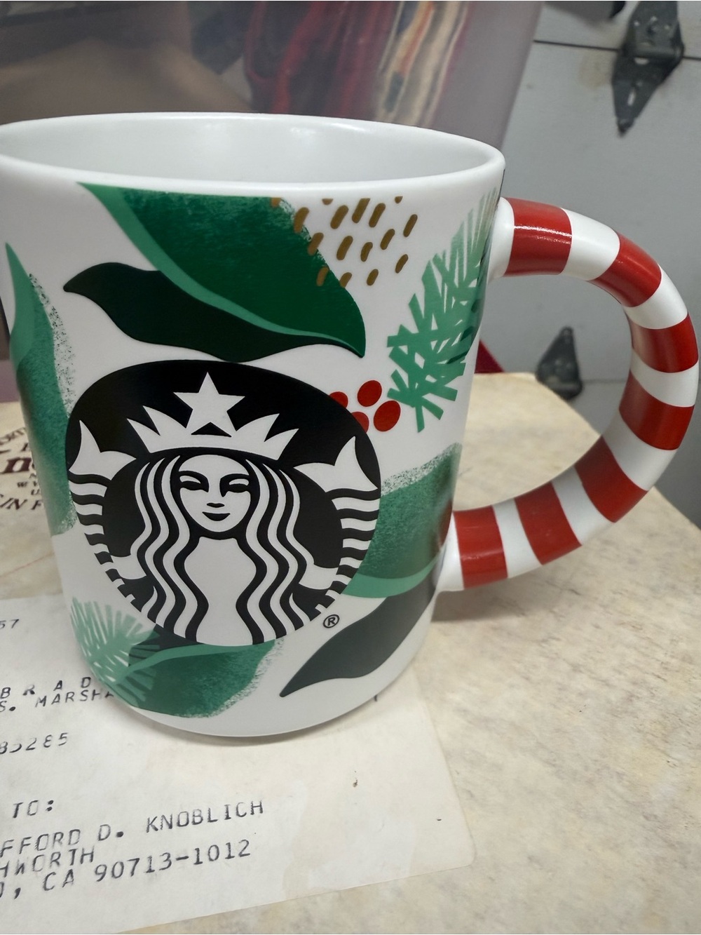 Starbucks White Ceramic Mug with Green Leaf Design and Red-White Striped Handle